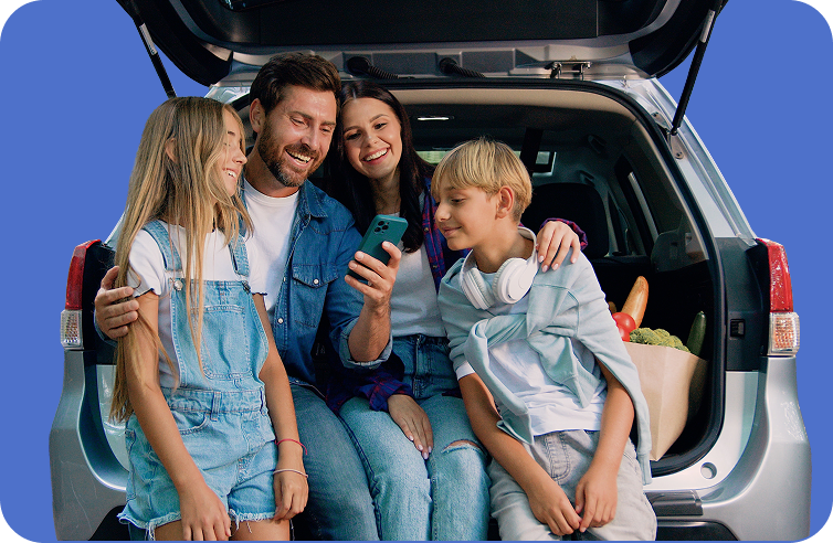 Happy family by their car after financing approval