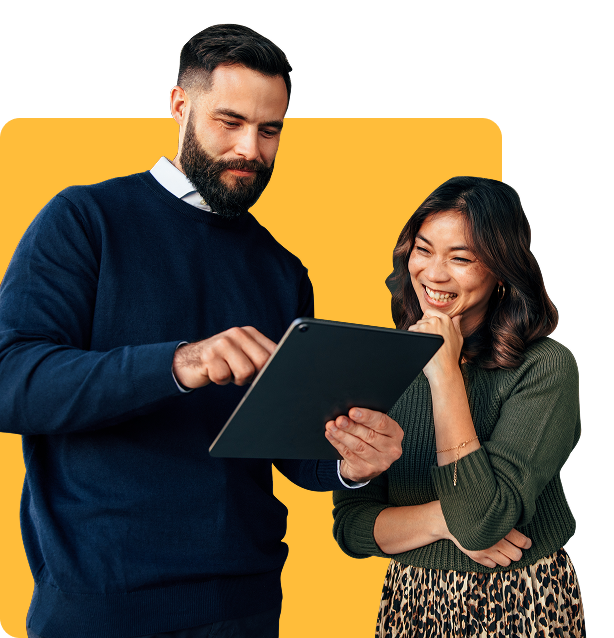 Two people reviewing a financing application on a tablet